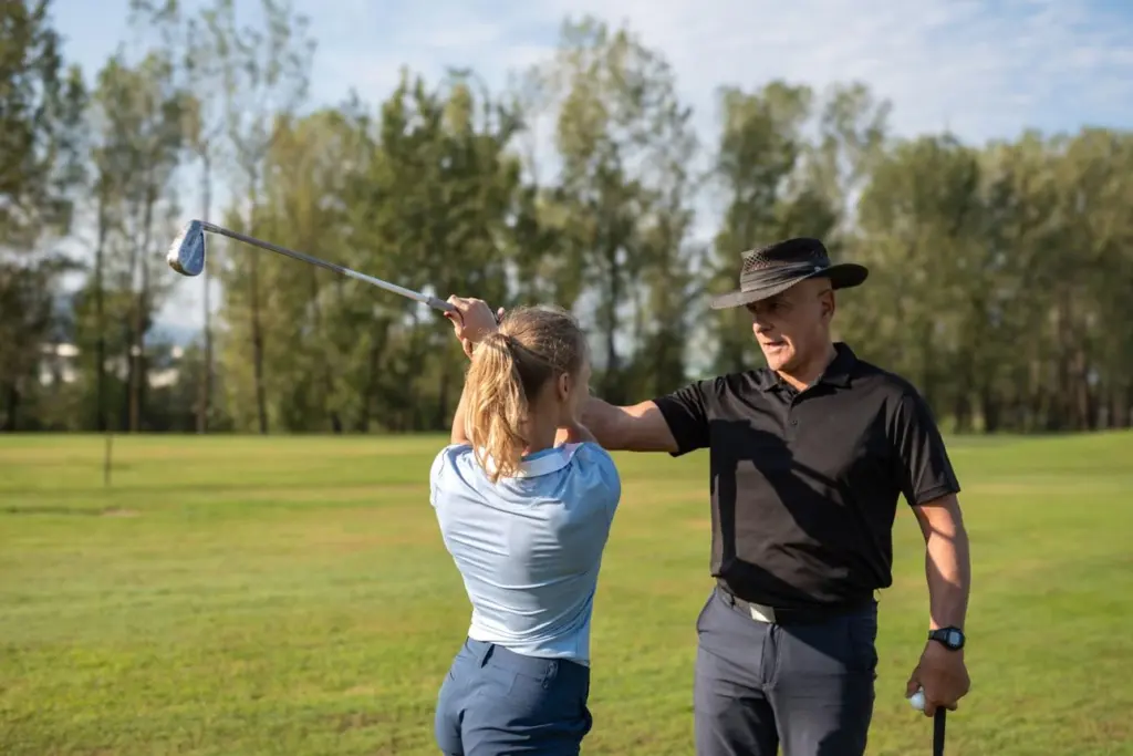 PGA instructors teach beginner golfers proper swing mechanics during private lessons.