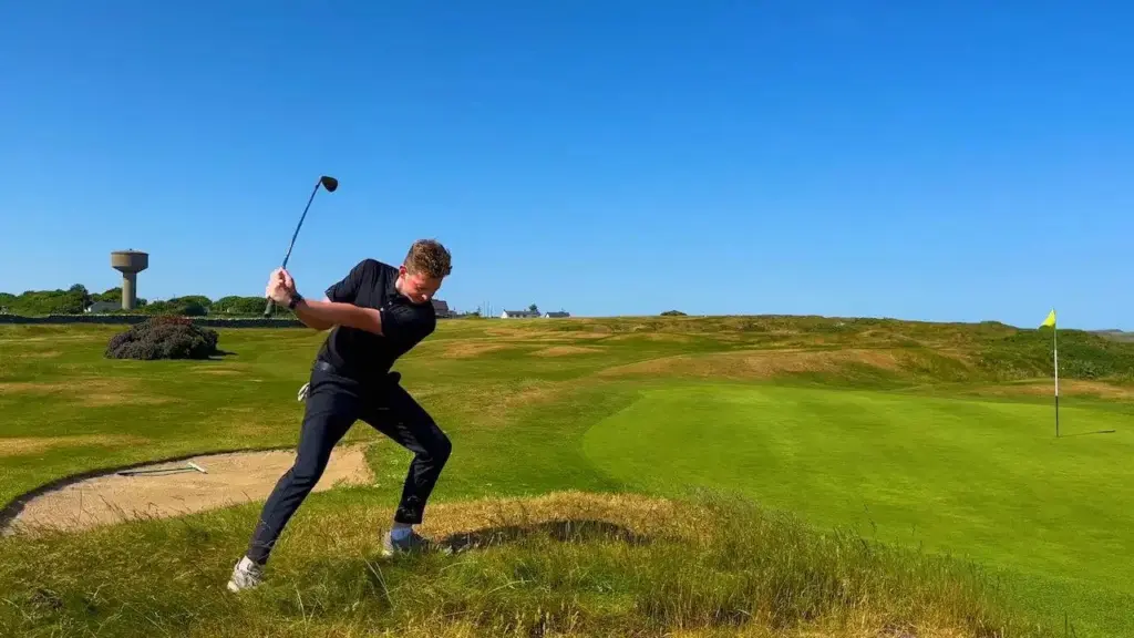 Golfers practice delicate wedge shots around tightly mowed putting greens.